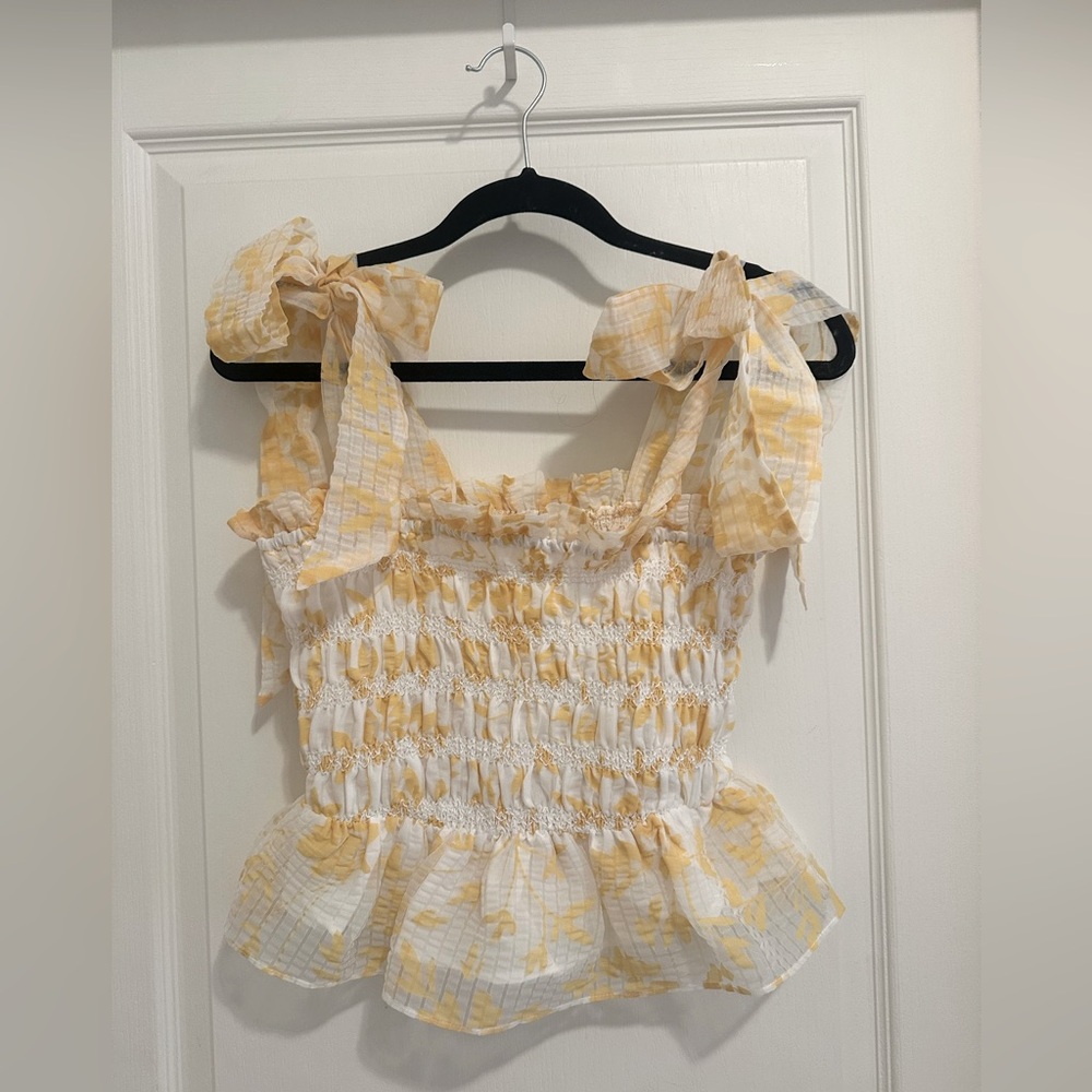En Saison Yellow and White peplum top with tied shoulders. Size small.